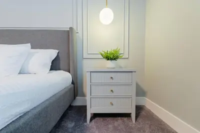 a white nightstand with a plant on it next to a bed at TR17145BD - 3 bedrooms home close to Disney in Orlando