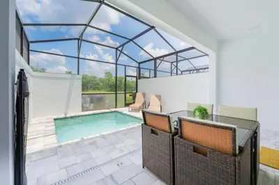 a house with a swimming pool with a glass ceiling at TR17145BD - 3 bedrooms home close to Disney in Orlando