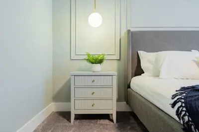 a nightstand with a plant on it next to a bed at TR17145BD - 3 bedrooms home close to Disney in Orlando