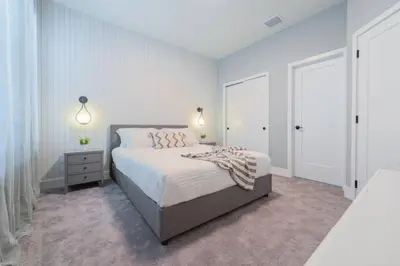 a white bedroom with a bed and a window at TR17145BD - 3 bedrooms home close to Disney in Orlando