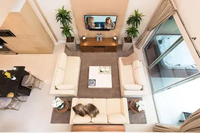 an overhead view of a living room with couches and a tv at Magic Village Yards Trademark Collection by Wyndham in Orlando
