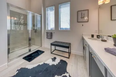 a bathroom with a shower and a sink at Experience Luxury in Your 11 En-Suites Mansion in Orlando