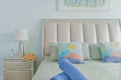 a bed with a headboard and a table with a lamp at Single-Level Home w Heated Pool & 9MI to Disney in Orlando