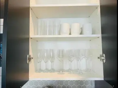 a cabinet with wine glasses in it at Tranquil Trail Bungalow in Kissimmee