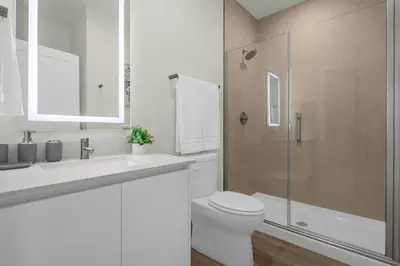 a bathroom with a toilet and a sink and a shower at Upstay - Modern Family Townhome with Pool in Orlando