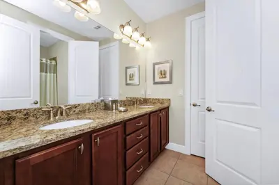 a bathroom with two sinks and a mirror at Charming Home Near Disney With Private Pool, Game Room And Waterpark & Resort Access At Encore Resorts Reunion - 410No in Kissimmee