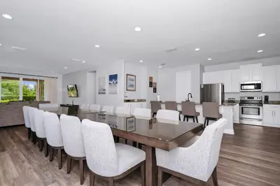 a kitchen and dining room with a table and chairs at Grand Home Near Disney With Private Pool And Waterpark & Resort Access At Encore Resorts Reunion - 7519Mr in Kissimmee