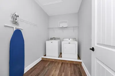 a laundry room with two washes and a stove at Grand Home Near Disney With Private Pool And Waterpark & Resort Access At Encore Resorts Reunion - 7519Mr in Kissimmee