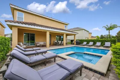 a swimming pool with lounge chairs and a house at Grand Home Near Disney With Private Pool And Waterpark & Resort Access At Encore Resorts Reunion - 7519Mr in Kissimmee