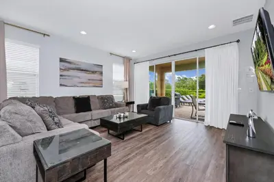 a living room with a couch and a table at Grand Home Near Disney With Private Pool And Waterpark & Resort Access At Encore Resorts Reunion - 7519Mr in Kissimmee