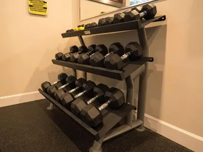 a rack of dumbbells on a wall at Clermont Family Townhouse Pool & Arcade near Disney in Orlando