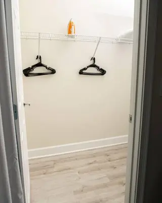 a hallway with two hangers on a white wall at Clermont Family Townhouse Pool & Arcade near Disney in Orlando