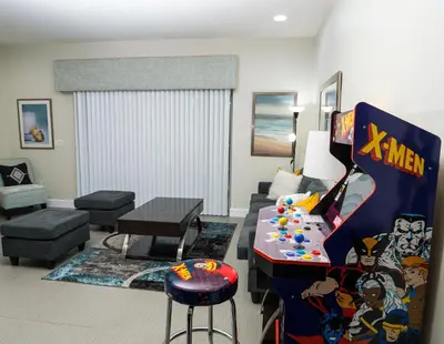 a living room with a video game at Clermont Family Townhouse Pool & Arcade near Disney in Orlando