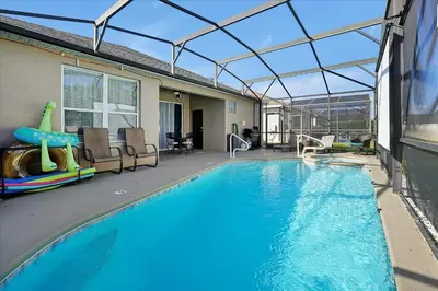 a swimming pool with a glass roof over it at Making Memories Resort -Windsor Palms Villa in Kissimmee