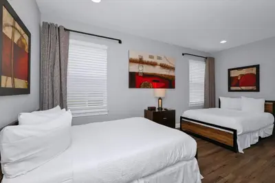 two beds in a room with white walls and windows at Glorious Home Near Disney With Game Room, Themed Rooms, Waterpark & Resort Access At Encore Resorts Reunion - 7643Wi in Kissimmee