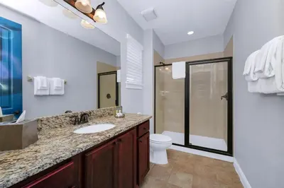 a bathroom with a sink and a toilet at Glorious Home Near Disney With Game Room, Themed Rooms, Waterpark & Resort Access At Encore Resorts Reunion - 7643Wi in Kissimmee