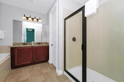 a bathroom with a shower and a sink at Glorious Home Near Disney With Game Room, Themed Rooms, Waterpark & Resort Access At Encore Resorts Reunion - 7643Wi in Kissimmee