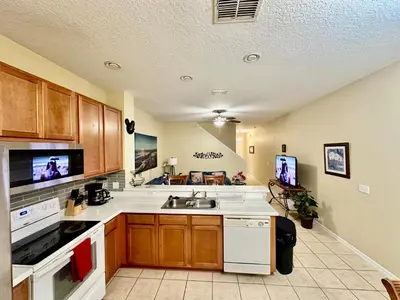 a kitchen with a sink and a stove at Grand Luxury 3BR Townhouse Near Disney Parks in Kissimmee