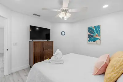 a bedroom with a bed and a ceiling fan at Tropical 7BR Heated Pool Pet Friendly Disney in Kissimmee