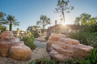 a garden with large rocks in front of a house at Disney's Coronado Springs Resort in Orlando