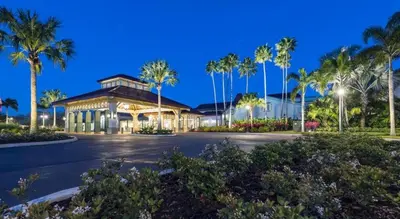 a building with palm trees in a parking lot at Disney's Caribbean Beach Resort in Orlando