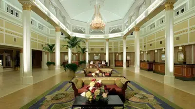 a large lobby with couches and a chandelier at Disney's Port Orleans Resort - French Quarter in Orlando