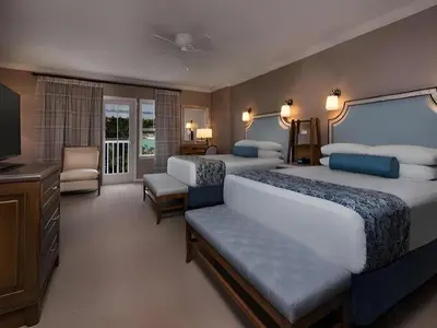 a hotel room with two beds and a television at Disney's Beach Club Resort in Orlando