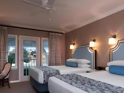a hotel room with two beds and a balcony at Disney's Beach Club Resort in Orlando