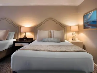 a bedroom with a large white bed with two lamps at Disney's Beach Club Resort in Orlando