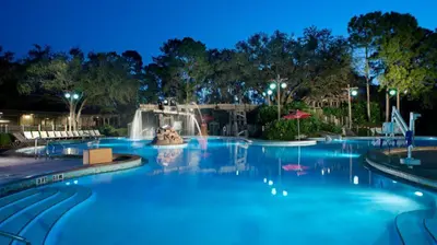 a swimming pool at a resort at night at Disney's Port Orleans Resort - Riverside in Orlando