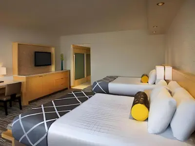 a hotel room with two beds and a flat screen tv at Disney's Contemporary Resort in Orlando
