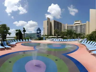 a swimming pool with lounge chairs and a resort at Disney's Contemporary Resort in Orlando