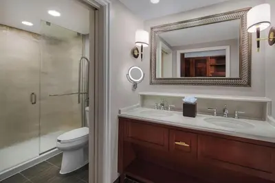 a bathroom with a sink and a toilet and a mirror at Disney's Yacht Club Resort in Orlando