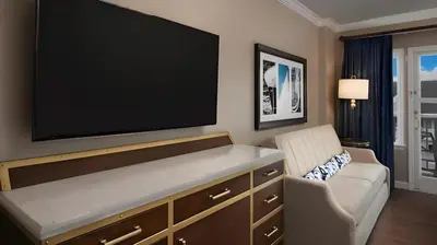 a living room with a large flat screen tv on the wall at Disney's Yacht Club Resort in Orlando