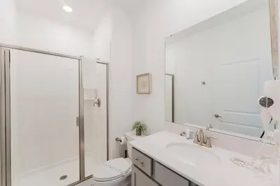 a bathroom with a shower and a sink and a toilet at 3017 SL new 11 guests heat pool BBQ near Disney in Kissimmee