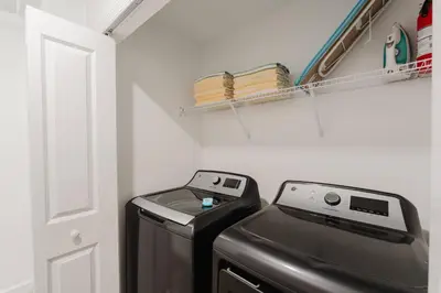 a washer and dryer in a laundry room at 3017 SL new 11 guests heat pool BBQ near Disney in Kissimmee