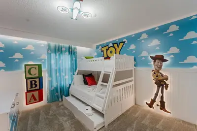a bedroom with a bed with a toy boy on the wall at 3017 SL new 11 guests heat pool BBQ near Disney in Kissimmee