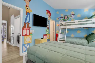 a bedroom with a bed with a superhero mural on the wall at Casa 3Q Windsor Hills, Piscina + Perto da Disney in Orlando