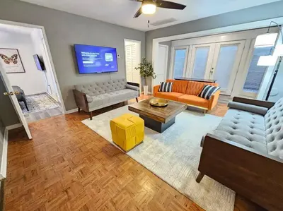a living room with a couch and a table at Foodie Lovers Walkable Mills50 - Sleeps 10 - Near Airport in Orlando