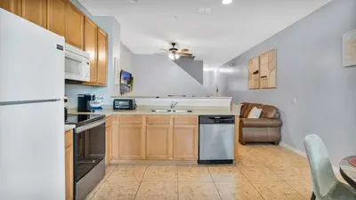 a kitchen with a refrigerator and a sink at Family Friendly Townhome Near Attractions in Orlando