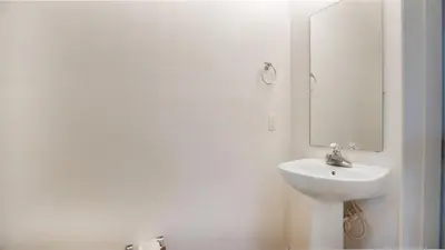 a white bathroom with a sink and a mirror at Quiet Corner Gem in Gated Crestwynd Bay in Orlando