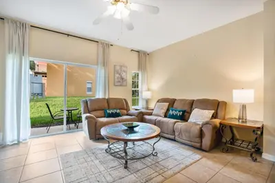 a living room with a couch and a table at Relaxing Getaway in Emerald Island Near Disney in Kissimmee
