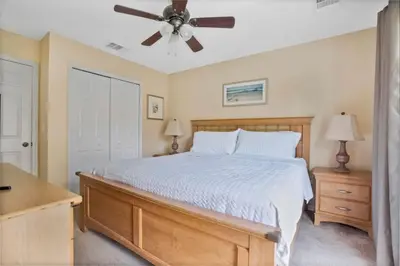 a bedroom with a bed and a ceiling fan at Relaxing Getaway in Emerald Island Near Disney in Kissimmee