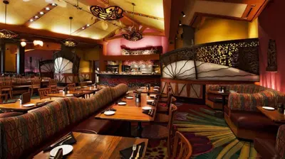 a restaurant with wooden tables and couches and a bar at Disney's Polynesian Village Resort in Orlando