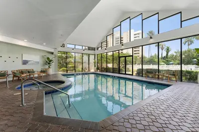 a large swimming pool in a building with windows at 15 - Amazing Vulcano Bay - Universal View in Orlando