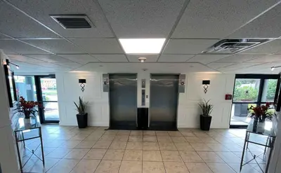 a hallway with two elevators in a building at 15 - Amazing Vulcano Bay - Universal View in Orlando