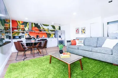 a living room with a couch and a table at StylishAptWtrGrdnOppLake&Prk&Yrd in Orlando