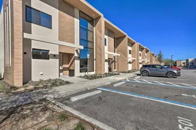 a car parked in a parking lot in front of a building at Luxury Magic Village 2mi to Disney TH7501 in Orlando