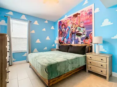 a bedroom with a bed with a large poster on the wall at T8134-Windsor Palms Resort Pool and Spa Near Disney in Kissimmee