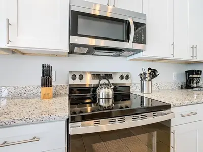 a kitchen with a stove and a microwave at T8134-Windsor Palms Resort Pool and Spa Near Disney in Kissimmee